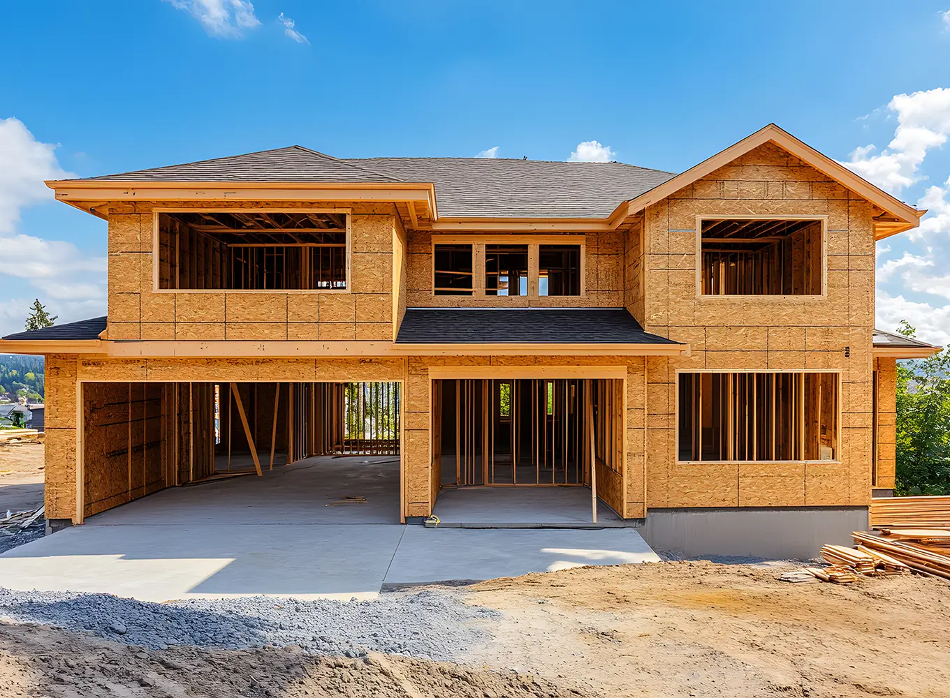Modern house under construction with wooden framework and open garage